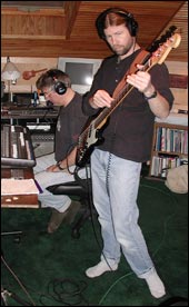 John Doerschuk at the mixing board and Kirk Foster on bass laying down a track. 